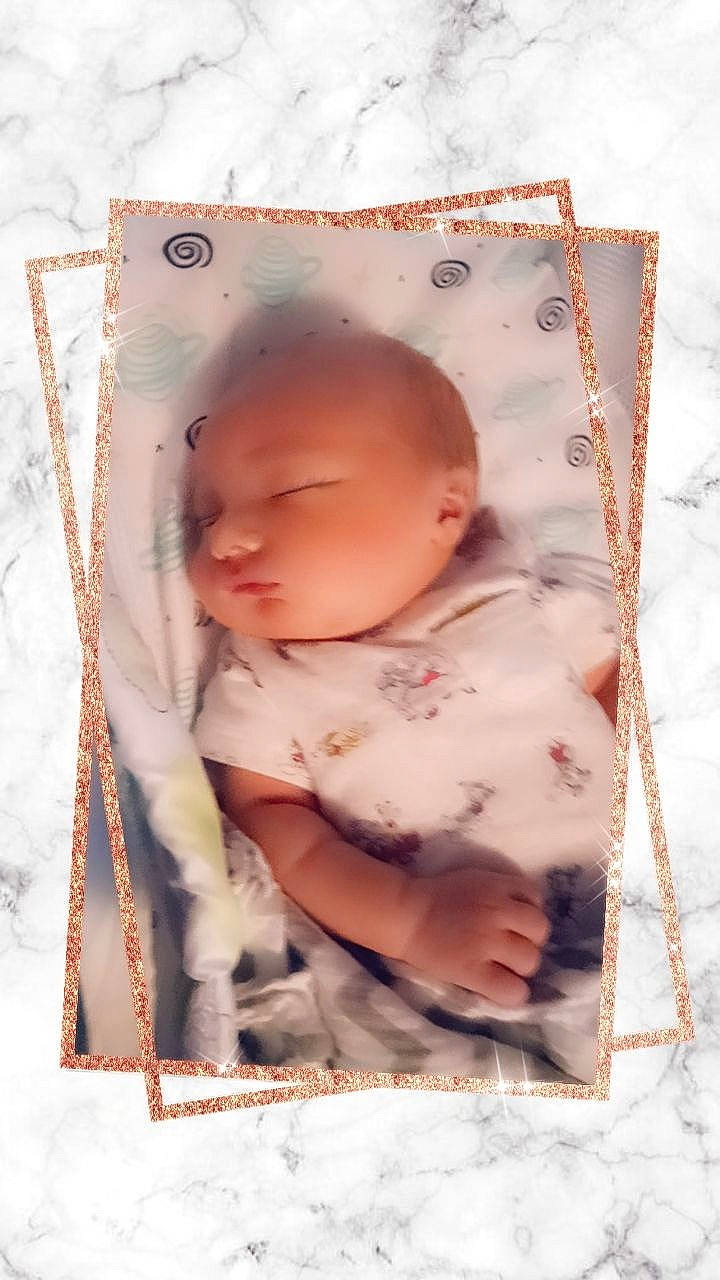Elijah is registered to the contest to win money with this photo: baby, baby_products, baby_sleeping, baby_toddler_clothing, child, comfort, happy, human_body, linens, pattern, peach, person, pink, portrait_photography, sitting, sleeve, toddler