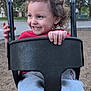 toddler, child, swing, playground, curly_hair, smile, happy, outdoor, park, red_shirt, gray_pants, hand, face, play, fun, daytime, nature, trees, seat, metal_chains