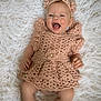 Ivy-Rose is registered to the contest to win money with this photo: baby, infant, crocheted_dress, headband, booties, smiling, happy, lying_down, fluffy_background, soft_texture, cute, child, portrait, hand, footwear, apparel, head_accessory, skin, person, indoors