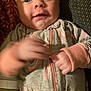 Rosalie joined the competition — help win amazing prizes! baby, infant, onesie, smile, hand, bottle, face, skin, fabric, pattern, zipper, texture, closeup, lying_down, cute, child, apparel, indoor, soft_lighting, person