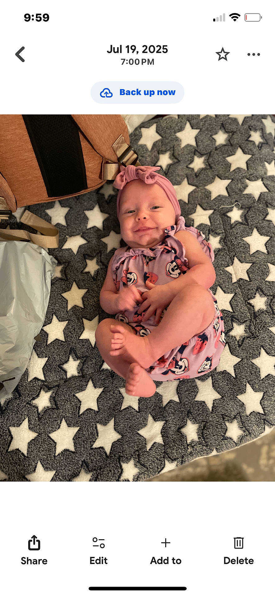 Rosalie is registered to the contest to win money with this photo: baby, bag, blanket, child, clothing, cute, fabric, floor, happy, headband, indoor, infant, lying_down, person, pink_outfit, portrait, small_feet, smile, soft_texture, star_pattern