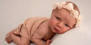 Ariella-Rae is registered to the contest to win money with this photo: baby, infant, newborn, headband, bow, blanket, soft_texture, skin, portrait, cute, pose, cushion, resting, closeup, expression, child, peaceful, indoor, light, adorable