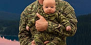 Brody joined the competition — help win amazing prizes! adult, baby, camouflage, child, clothing, forest, holding, infant, lake, landscape, man, military_uniform, mountain, nature, outdoor, person, portrait, scenery, sky, sunset