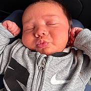 Zakaius is registered to the contest to win money with this photo: baby, chubby_cheeks, closeup, clothing, cute, face, fist, hand, head, hoodie, indoor, infant, newborn, nike, person, portrait, puckered_lips, skin, sleeping, zipper