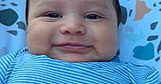 Zakaius joined the competition — help win amazing prizes! baby, smiling, face, blue_shirt, striped_clothing, infant, patterned_background, outdoor, cheeks, portrait, happy, child, cute, closeup, reclining, expression, person, baby_clothes, head, skin