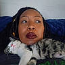 Lina is registered to the contest to win money with this photo: woman, person, cat, kitten, pet, portrait, selfie, indoors, bedroom, blanket, couch, sleeping, relaxed, face, hair, makeup, whiskers, fur, gray_and_white, cuddling