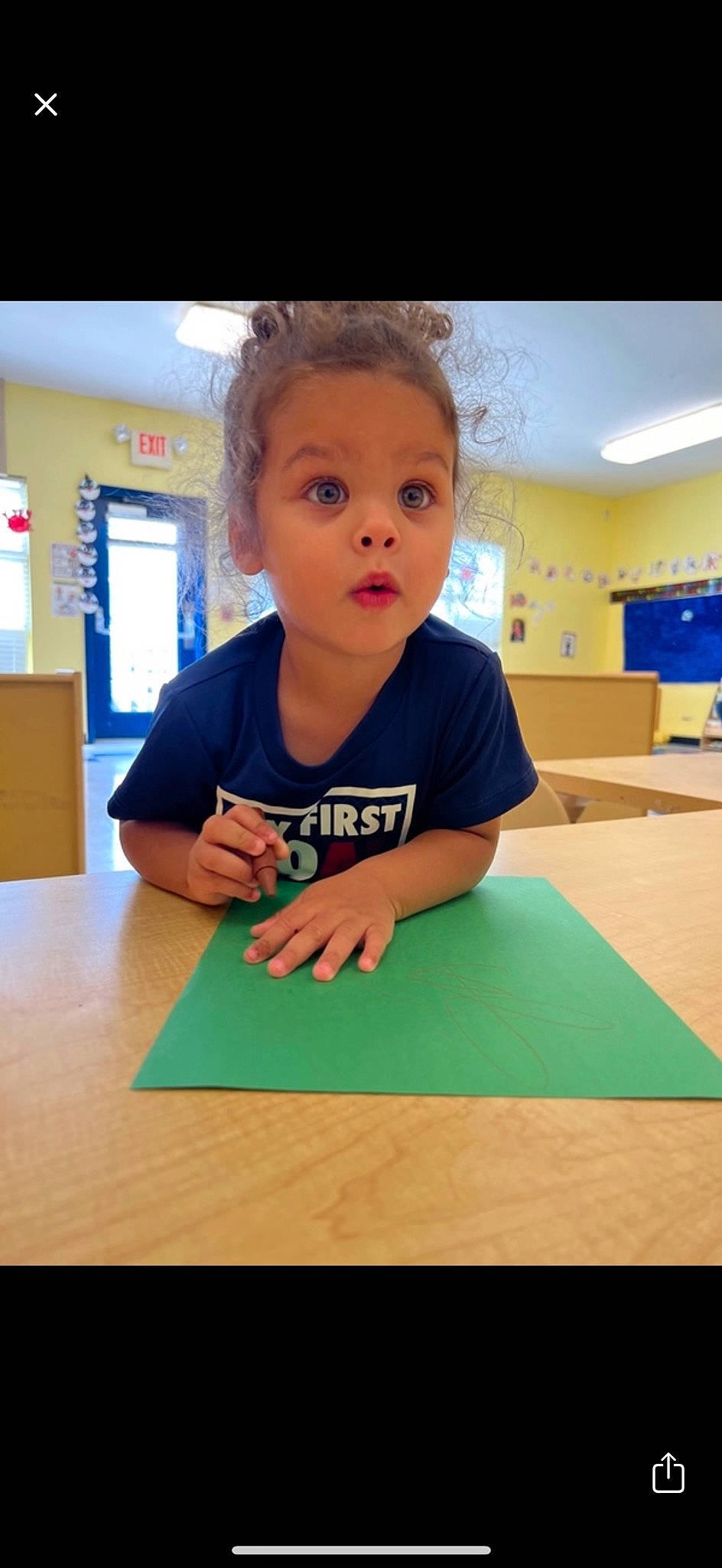 Kyrie joined the competition — help win amazing prizes! chair, child, desk, education, flooring, fun, learning, leisure, person, play, recreation, room, school, sitting, surprise, t_shirt, table, teacher, toddler, wood