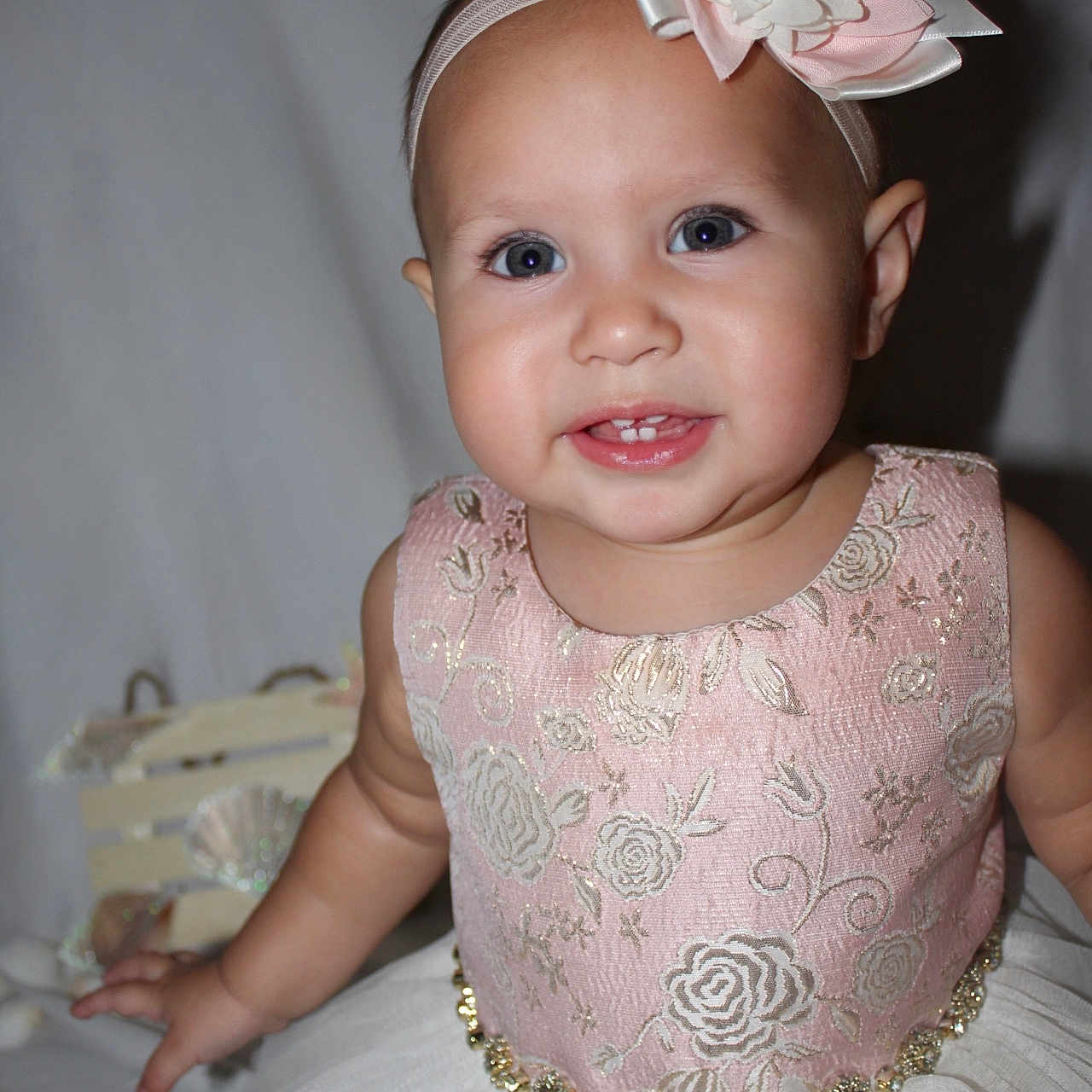 Celina is registered to the contest to win money with this photo: accessories, baby, bodypart, clothing, dress, eveningdress, face, finger, flower, flowerarrangement, flowerbouquet, formalwear, hand, hat, head, headband, person, photography, plant, portrait