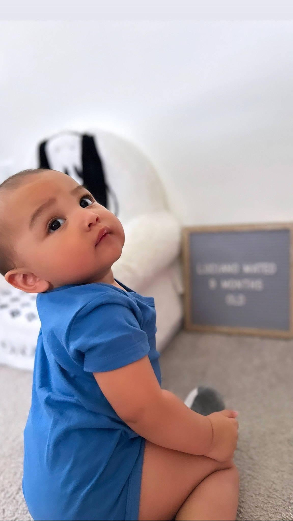 Luciano is registered to the contest to win money with this photo: arm, baby, baby_toddler_clothing, child, elbow, electric_blue, eye, flash_photography, fun, happy, head, human_body, human_leg, joint, knee, person, sitting, skin, sleeve, t_shirt