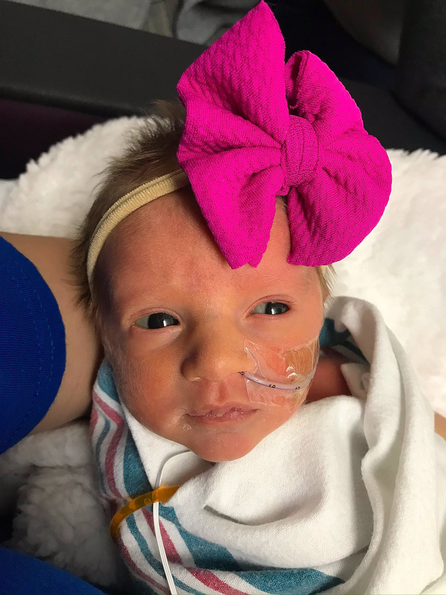 Meredith is registered to the contest to win money with this photo: baby, baby_products, baby_toddler_clothing, cheek, child, costume_accessory, hair_accessory, headband, headgear, linens, magenta, person, pink, textile, toddler