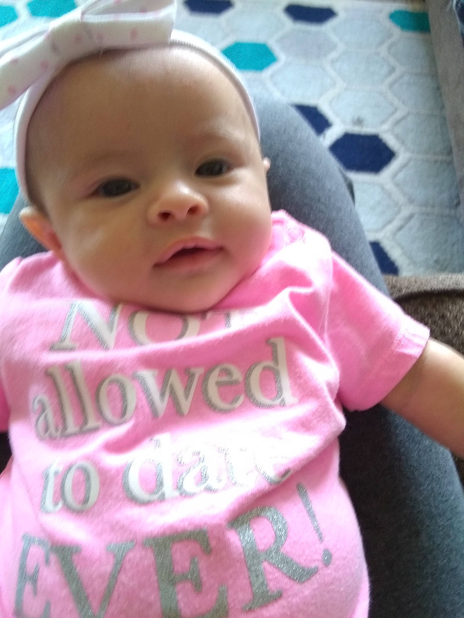 Layla is registered to the contest to win money with this photo: baby, baby_safety, baby_toddler_clothing, cheek, child, eyebrow, eyelash, happy, iris, lip, magenta, mouth, nose, person, pink, skin, sleeve, smile, t_shirt, textile