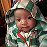 Zayvion is registered to the contest to win money with this photo: baby, child, hoodie, green_stripes, orange_zipper, cute, portrait, indoor, soft_lighting, cozy, infant, face, expression, warm_clothing, blanket, pattern, person, young, smile, closeup