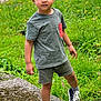 Nathaniel a rejoint le concours — aidez-le/la à gagner de superbes lots ! black_sneakers, casual_clothing, child, confident, curly_hair, cute, dinosaur_print, flowers, grass, green_shorts, green_tshirt, high_top_shoes, moss, nature, outdoor, path, standing, summer, toddler, young_child