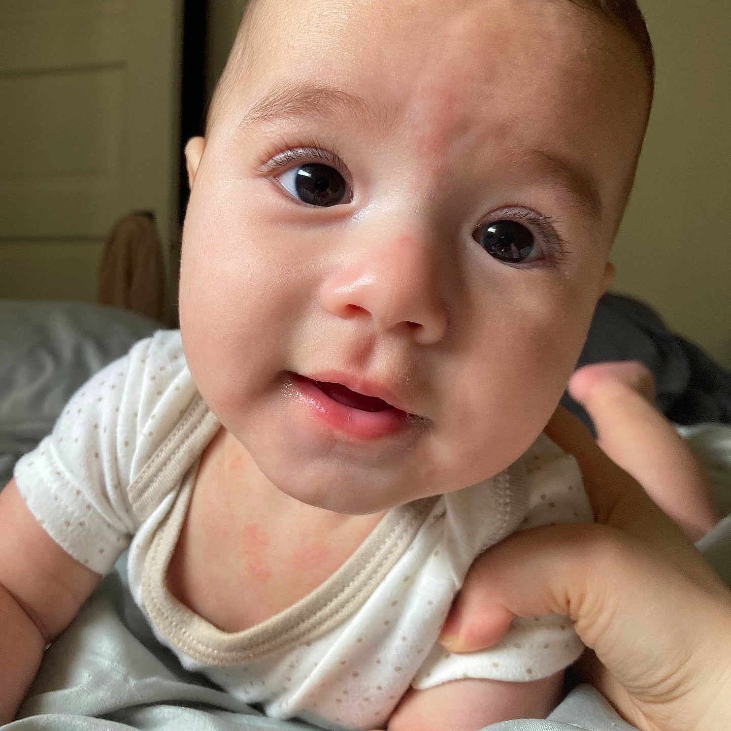 Jamiel is registered to the contest to win money with this photo: baby, bed, blanket, child, clothing, cute, expression, eyes, face, hand, indoors, infant, mouth, newborn, person, portrait, skin, sleepwear, soft, toddler