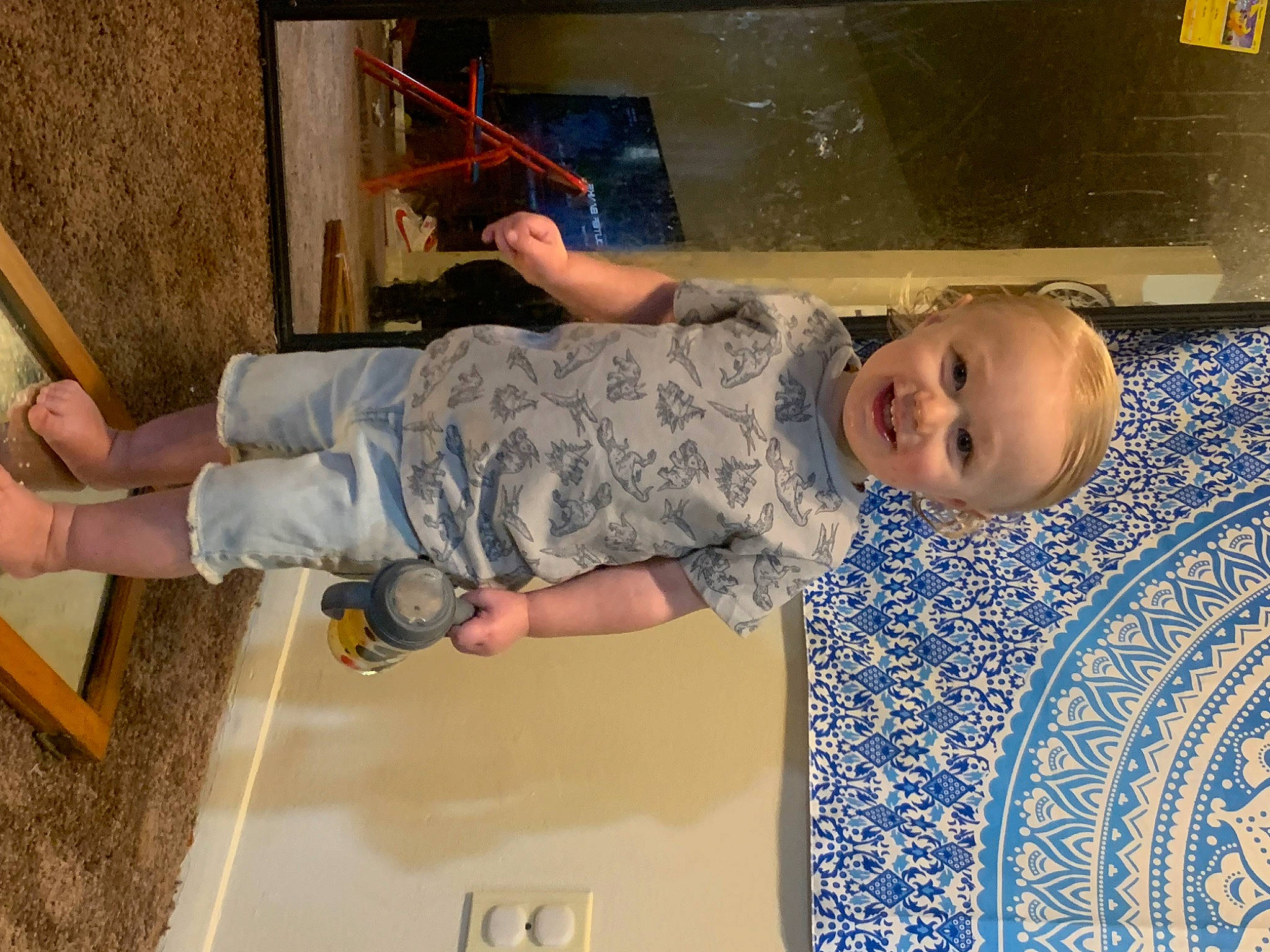 Kobe is registered to the contest to win money with this photo: baby, baby_toddler_clothing, child, comfort, flooring, fun, hand, happy, joy, leisure, pattern, person, play, room, sitting, smile, t_shirt, toddler, wood