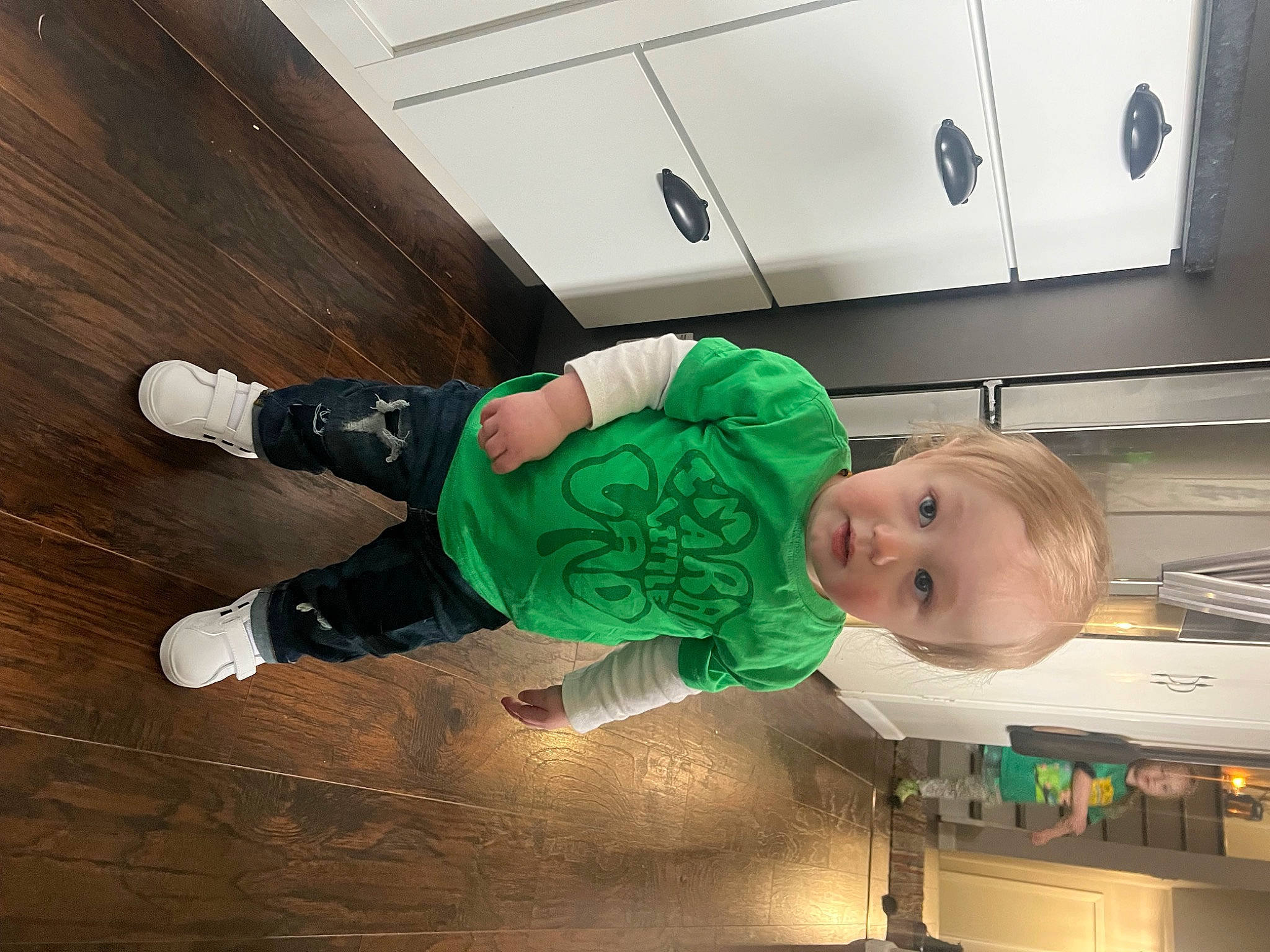 Kobe is registered to the contest to win money with this photo: baby, child, cloud, comfort, fictional_character, flooring, fun, happy, hardwood, hat, human_leg, person, room, sitting, smile, sock, sportswear, toddler, walking_shoe, wood