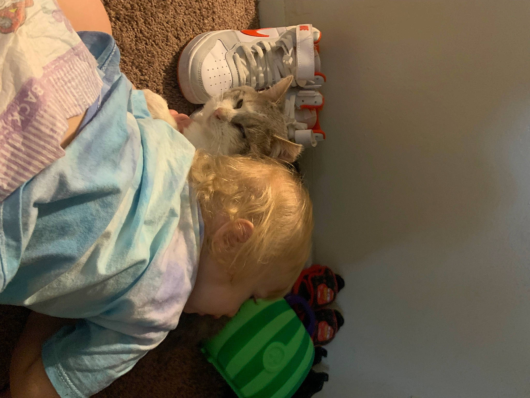 Kobe is registered to the contest to win money with this photo: baby, child, comfort, denim, flooring, foot, hat, human_leg, person, room, sitting, stuffed_toy, textile, toddler, toy, visual_arts, wood
