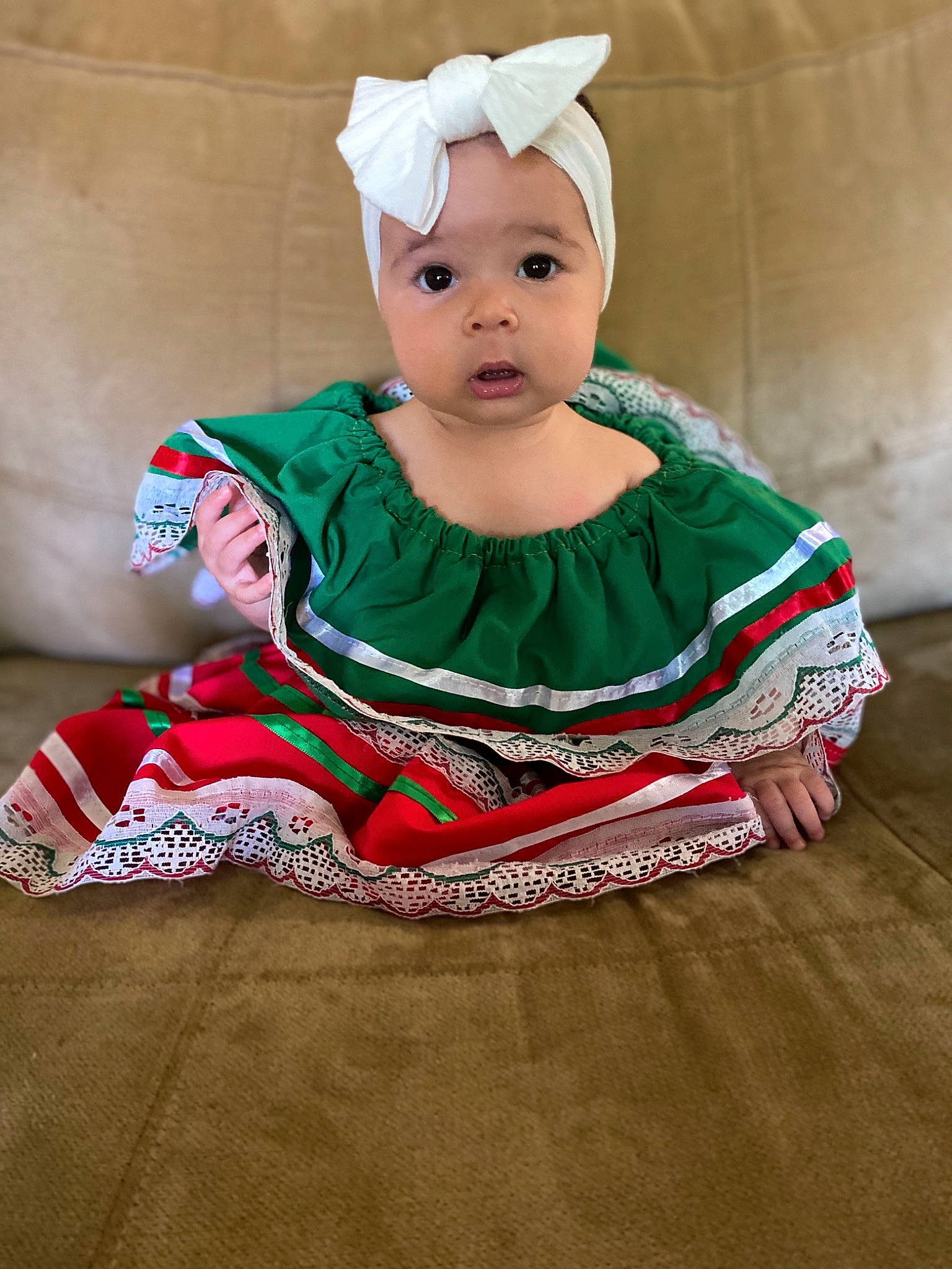 Jazlyn is registered to the contest to win money with this photo: baby, child, costume, hair_accessory, headwear, person, sitting, sleeve, smile, surprise, toddler
