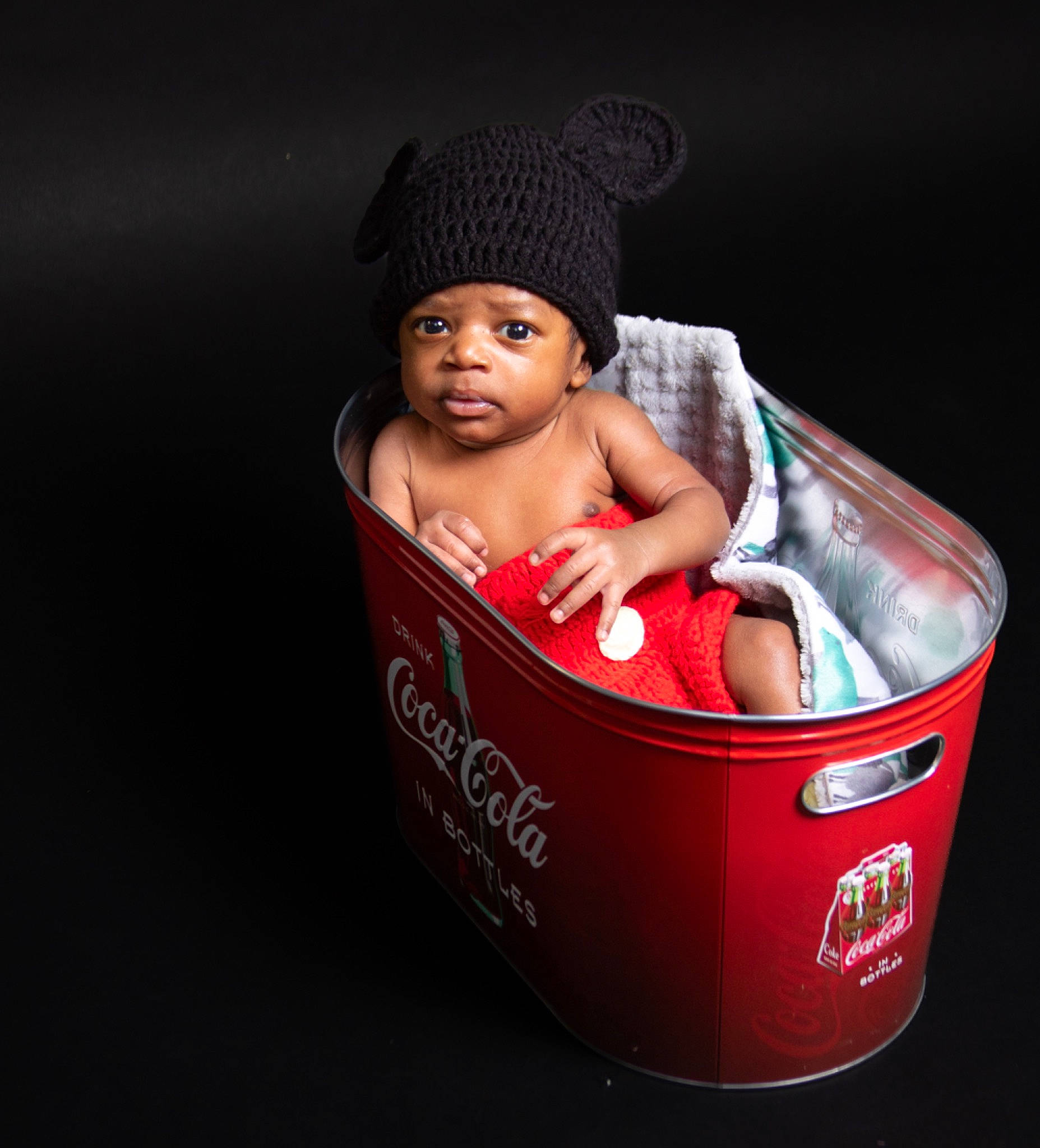 Casey is registered to the contest to win money with this photo: baby, baby_products, baby_safety, baby_toddler_clothing, beanie, box, cap, carmine, carton, child, eye, fashion_accessory, font, headwear, knit_cap, metal, packaging_and_labeling, person, plastic, toddler