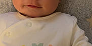 Callen joined the competition — help win amazing prizes! baby, infant, face, smile, clothing, blanket, star_pattern, lying_down, cute, child, soft_texture, close_up, indoors, apparel, person, newborn, pastel_colors, sleepwear, portrait, expression
