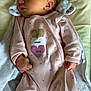 baby, newborn, sleeping, infant, onesie, pink_clothing, heart_pattern, pillow, blanket, soft_fabric, cute, peaceful, fist, face, skin, head, ear, indoor, rest, child
