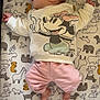 baby, sleeping, infant, blanket, animal_print, minnie_mouse, sweater, pink_pants, feet, hands, lying_down, bed, cute, peaceful, indoors, child, portrait, soft, cozy, rest