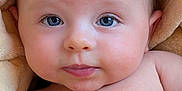 Enola joined the competition — help win amazing prizes! baby, infant, face, blue_eyes, skin, blanket, close_up, portrait, child, cute, expression, soft, newborn, head, chest, warm, comfort, natural_light, peaceful, young