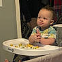 toddler, child, high_chair, food, meal, indoor, clothing, pajamas, hands, face, expression, tray, baby, feeding, safety, furniture, foot, hair, room, person