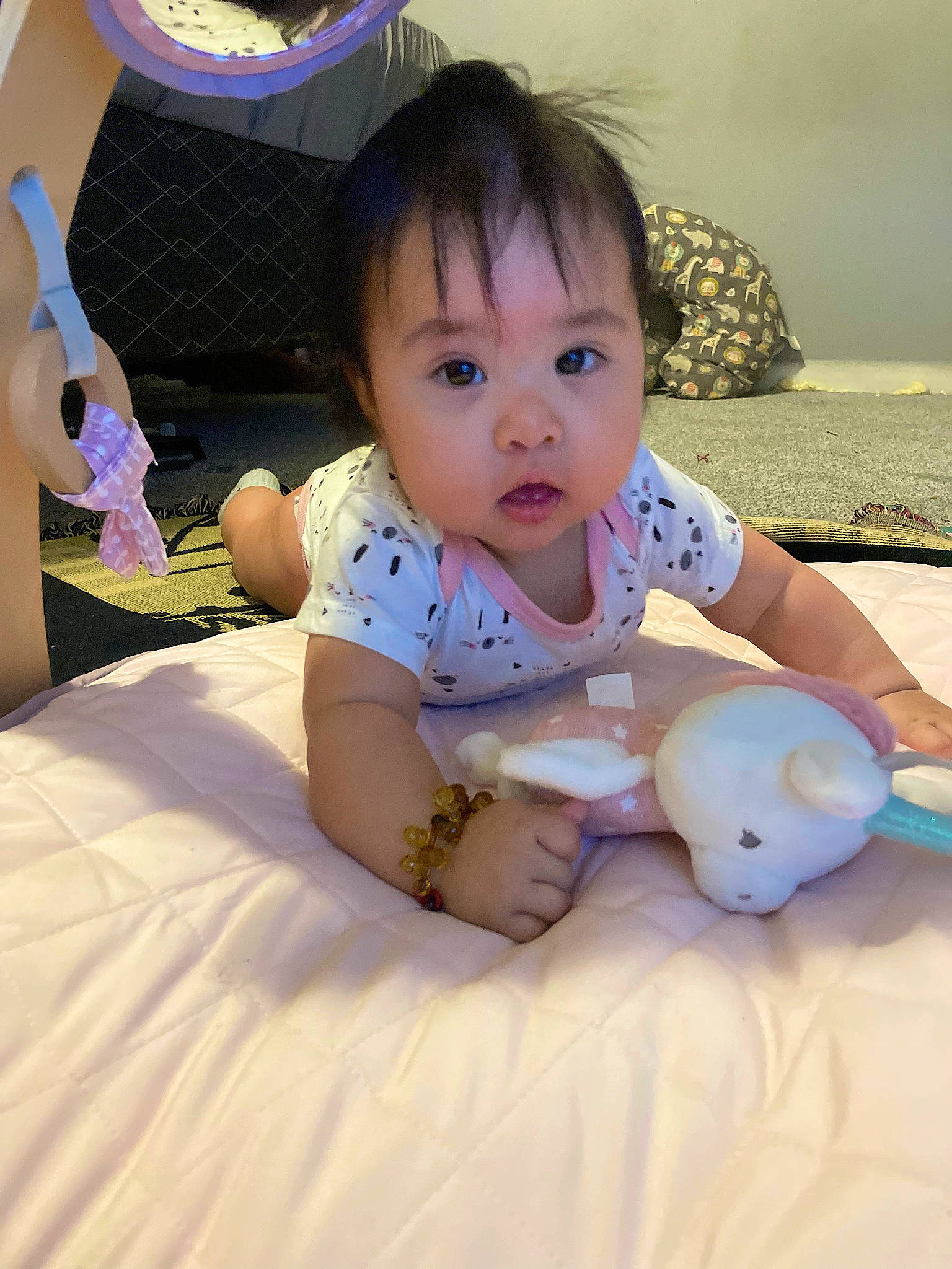 Delilah is registered to the contest to win money with this photo: baby, baby_toddler_clothing, cheek, comfort, facial_expression, finger, fun, happy, head, human_body, lap, leg, leisure, linens, person, pink, room, sitting, skin, textile