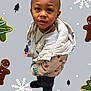 Jayden is registered to the contest to win money with this photo: toddler, child, winter_jacket, necklace, curious, gingerbread_man, cookie, snowflake, holiday_theme, festive_background, smiling, standing, clothing, outerwear, cute, portrait, indoors, fashion, young_child, casual
