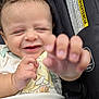 Scheffen is registered to the contest to win money with this photo: baby, child, smiling, curly_hair, hand, car_seat, safety_label, infant, cute, reaching, happy, closeup, seatbelt, clothing, young_child, portrait, toddler, indoor, skin, person