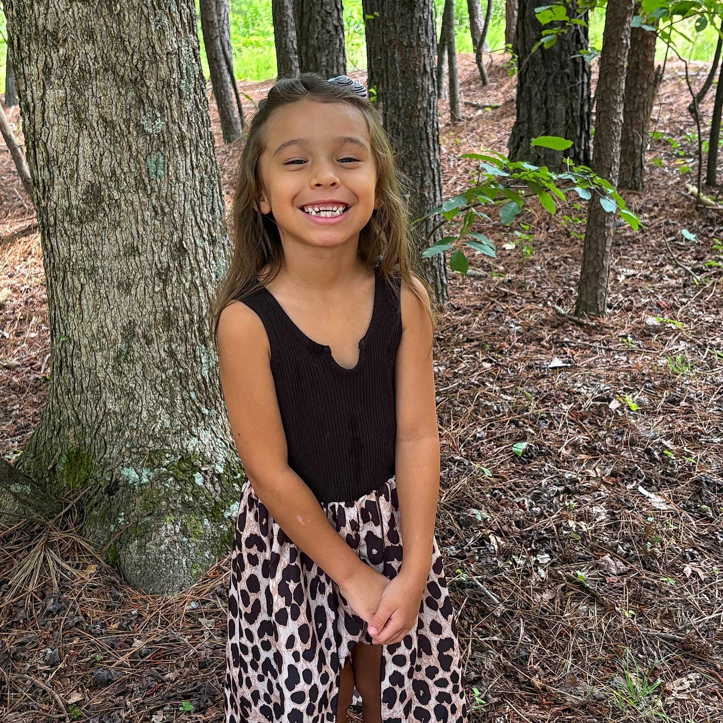 Madison joined the competition — help win amazing prizes! black_top, casual_clothing, child, dress, forest, girl, gold_shoes, happy, leaves, leopard_print, nature, outdoor, person, plant, smiling, standing, sunlight, tree, woodland, young