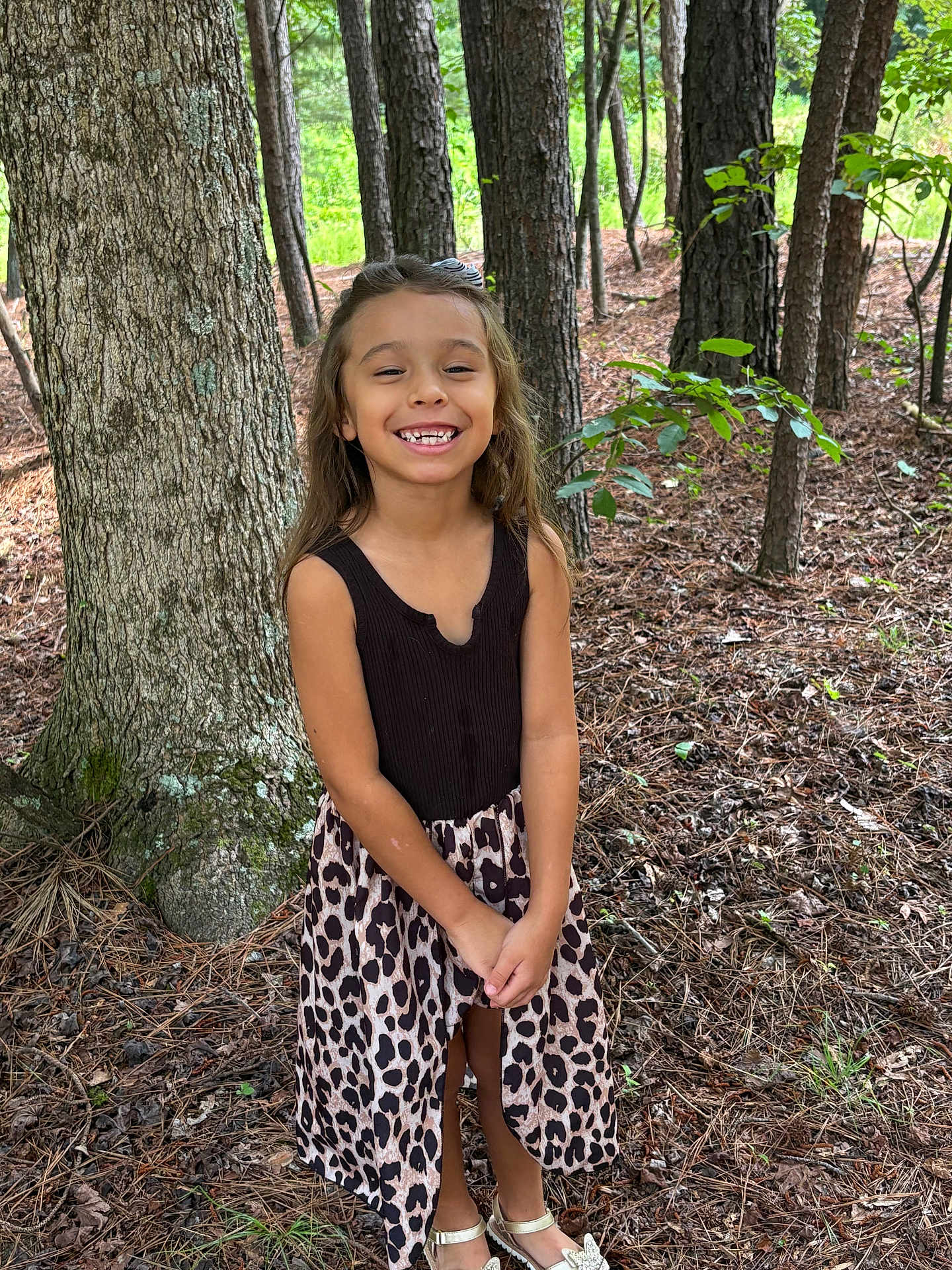 Madison joined the competition — help win amazing prizes! child, girl, smiling, forest, tree, leaves, nature, outdoor, dress, black_top, leopard_print, gold_shoes, standing, happy, young, sunlight, plant, woodland, casual_clothing, person
