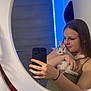 mirror, selfie, woman, kitten, cat, smartphone, bedroom, blue_led_lights, door, smile, holding, long_hair, casual_clothing, reflection, indoor, young_adult, cute, pet, affection, technology