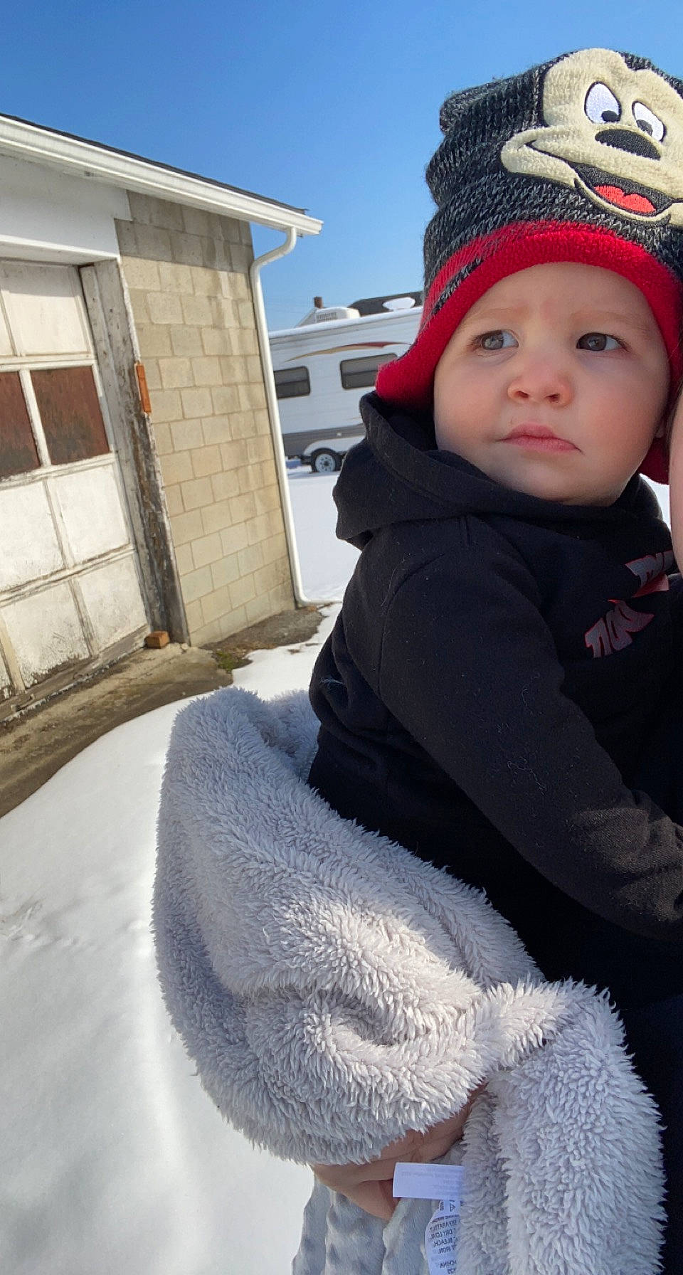 Maverick is registered to the contest to win money with this photo: cap, fashion_accessory, freezing, fun, fur, head, headgear, headwear, jacket, knit_cap, mammal, person, recreation, sky, snow, street_fashion, toddler, tree, vertebrate, window