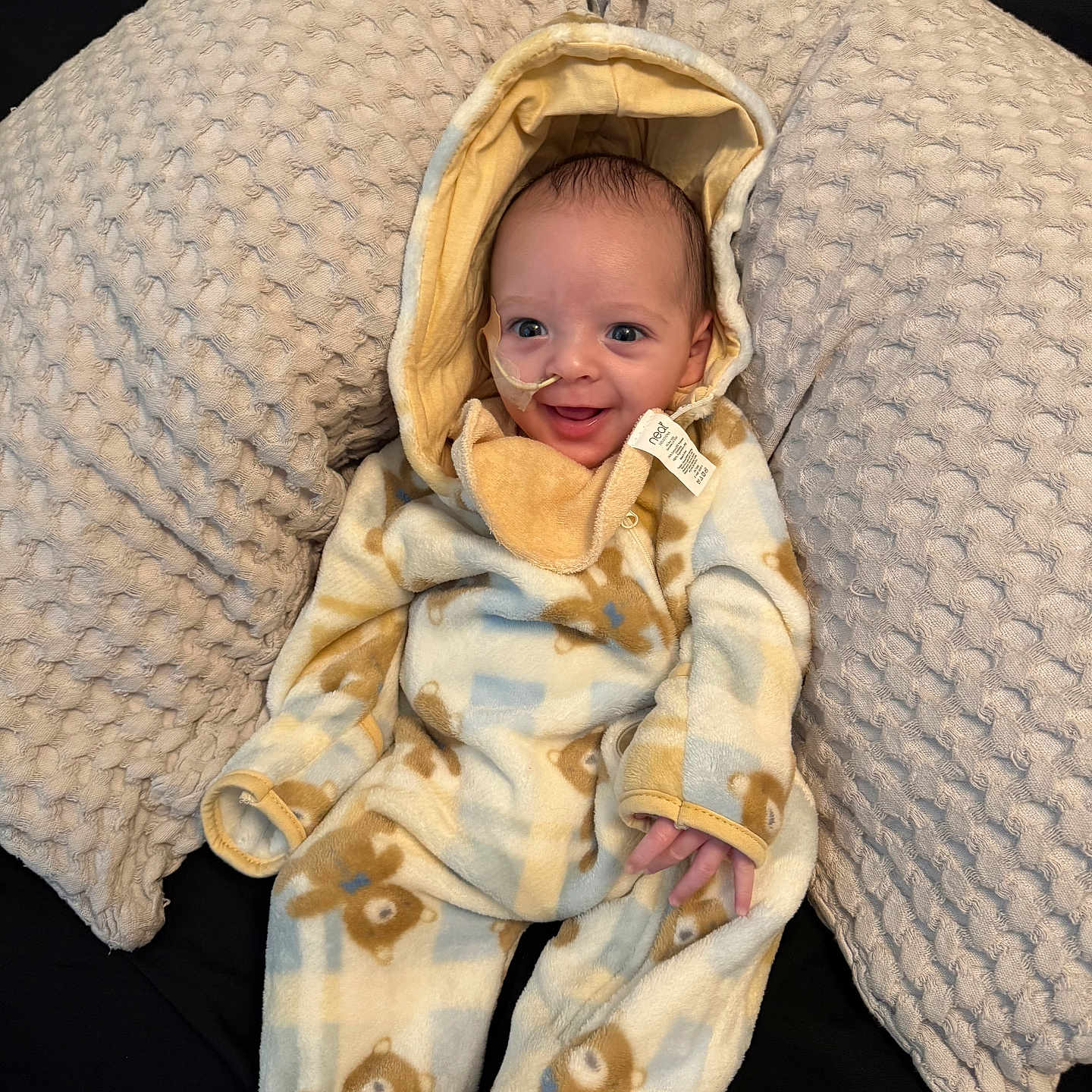 Elliott is registered to the contest to win money with this photo: baby, bed, blanket, bonnet, clothing, couch, face, furniture, happy, hat, head, hood, knitwear, newborn, person, photography, portrait, quilt, smile, sweater
