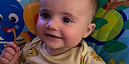 Tatum joined the competition — help win amazing prizes! baby, child, smiling, face, infant, cute, indoors, seat, colorful, cartoon, playful, clothing, sun_pattern, happy, portrait, young, person, baby_toy, background, closeup