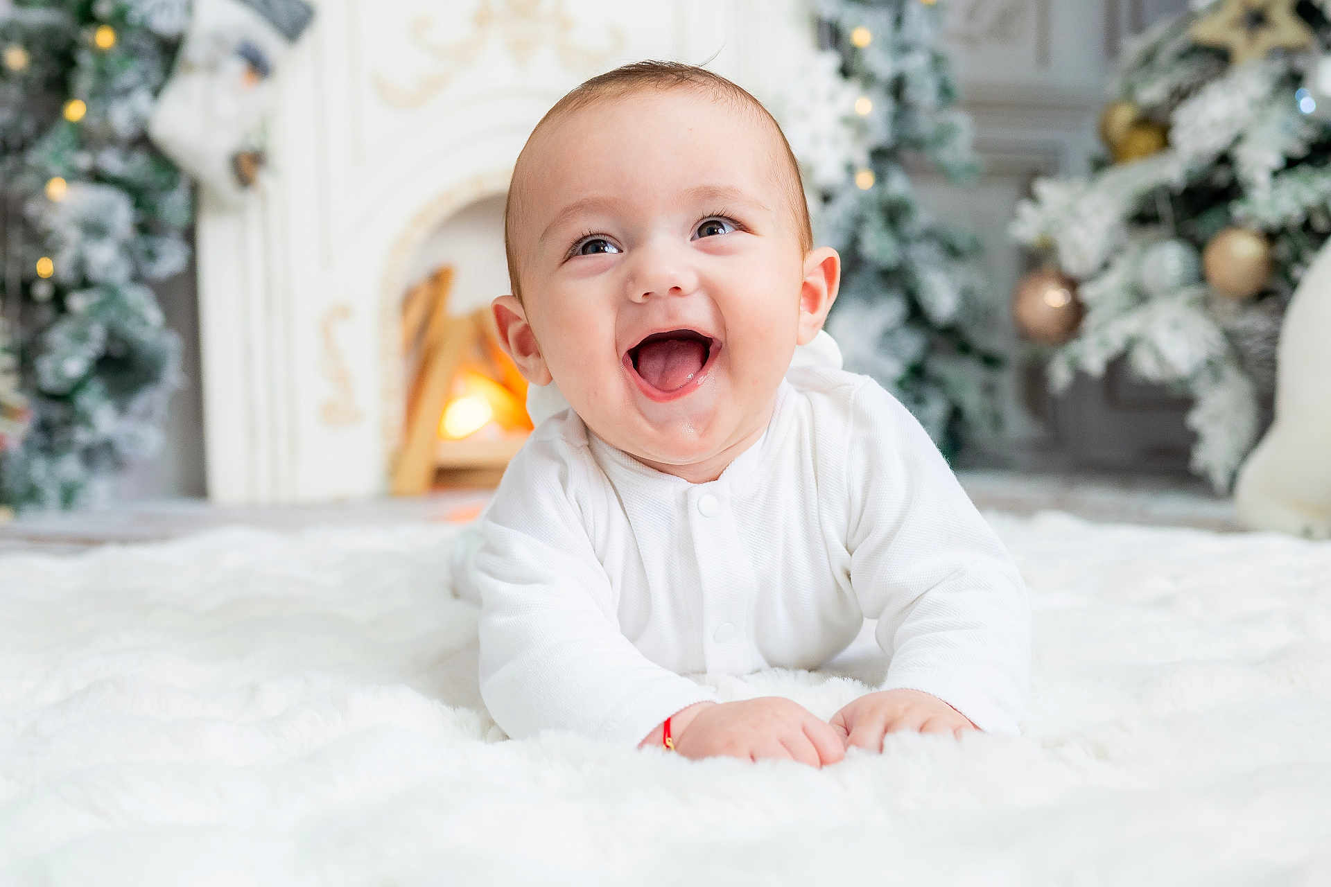 Patrick joined the competition — help win amazing prizes! baby, infant, smiling, white_clothing, blanket, fireplace, christmas_tree, holiday_decor, indoors, cute, happy, toddler, face, child, warmth, festive, cozy, holiday, celebration, portrait