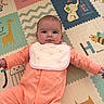 baby, infant, onesie, bib, playmat, alphabet, animal_illustrations, giraffe, elephant, duck, owl, bee, floor, child, cute, indoor, playtime, smiling, person, young