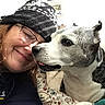 Bebe is registered to the contest to win money with this photo: close_up, couch, cuddling, dog, framed_photo, glasses, hat, indoor, knit_hat, patterned, paw, pet, pillow, portrait, selfie, senior_person, smile, tongue_out, wall_art, woman