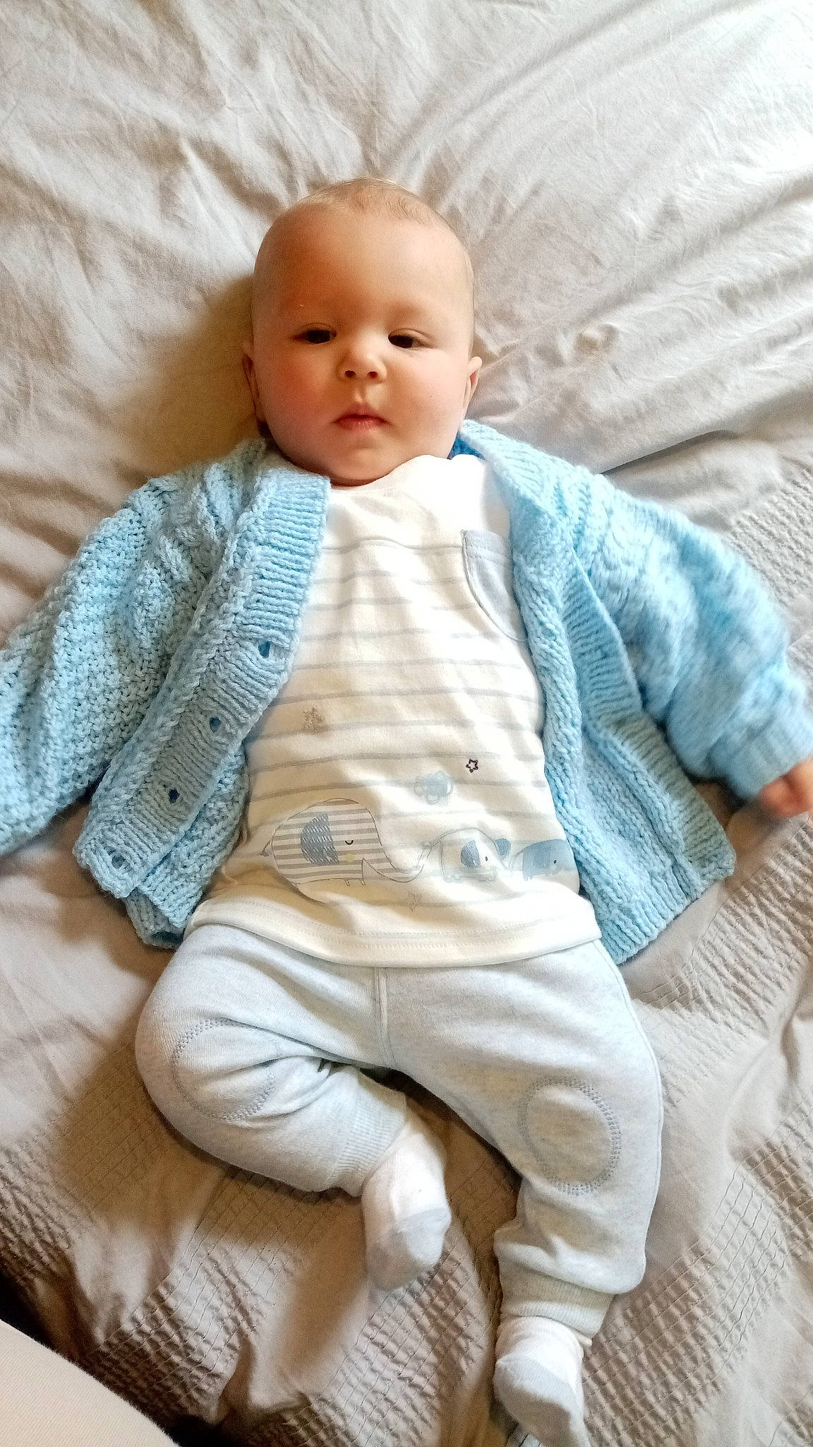 Lenox is registered to the contest to win money with this photo: baby, baby_sleeping, baby_toddler_clothing, cheek, collar, comfort, dress_shirt, face, linens, neck, nose, pattern, person, sitting, skin, sleeve, smile, textile, toddler, wood