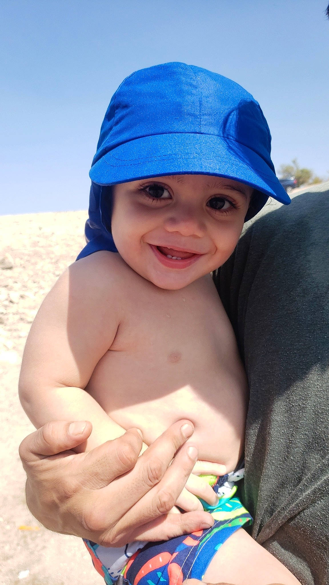Aero is registered to the contest to win money with this photo: aeolian_landform, azure, baby_toddler_clothing, barechested, blue, bonnet, bracelet, child, desert, electric_blue, finger, headgear, headwear, joy, muscle, nail, organ, person, sand, skin