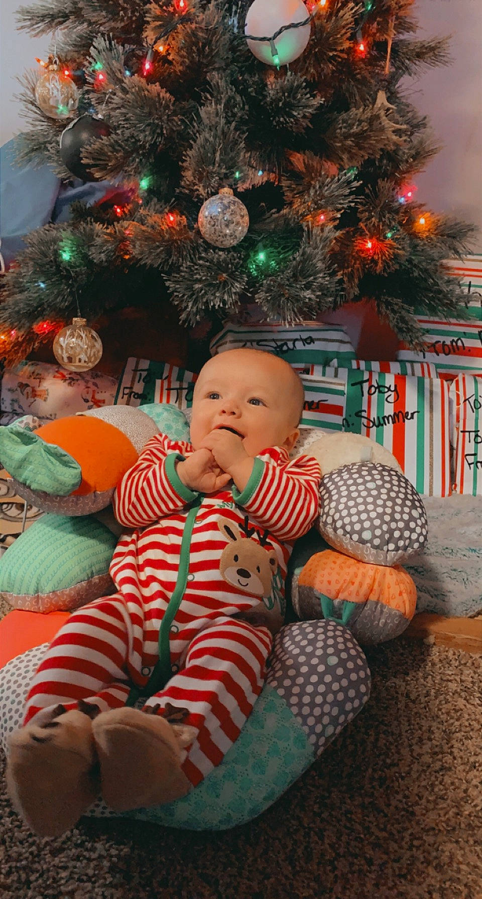 Keenan joined the competition — help win amazing prizes! baby, baby_toddler_clothing, christmas, christmas_decoration, christmas_ornament, christmas_tree, event, fun, grass, green, happy, head, holiday, holiday_ornament, human_body, ornament, person, plant, smile, toddler
