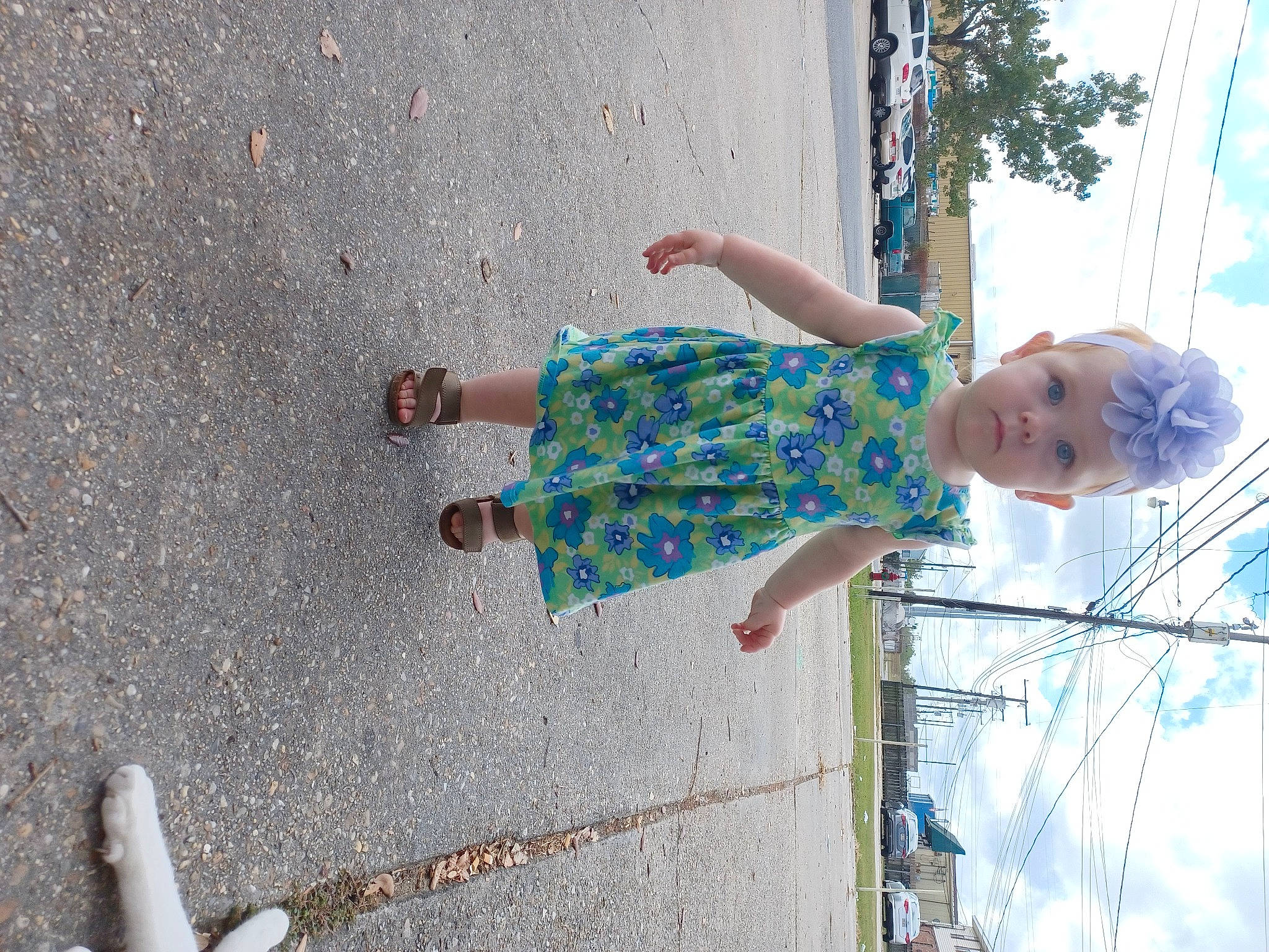 Kynslee is registered to the contest to win money with this photo: asphalt, child, city, cloud, concrete, foot, fun, happy, headwear, human_leg, human_settlement, leisure, person, play, recreation, road_surface, sidewalk, sky, thigh, toddler