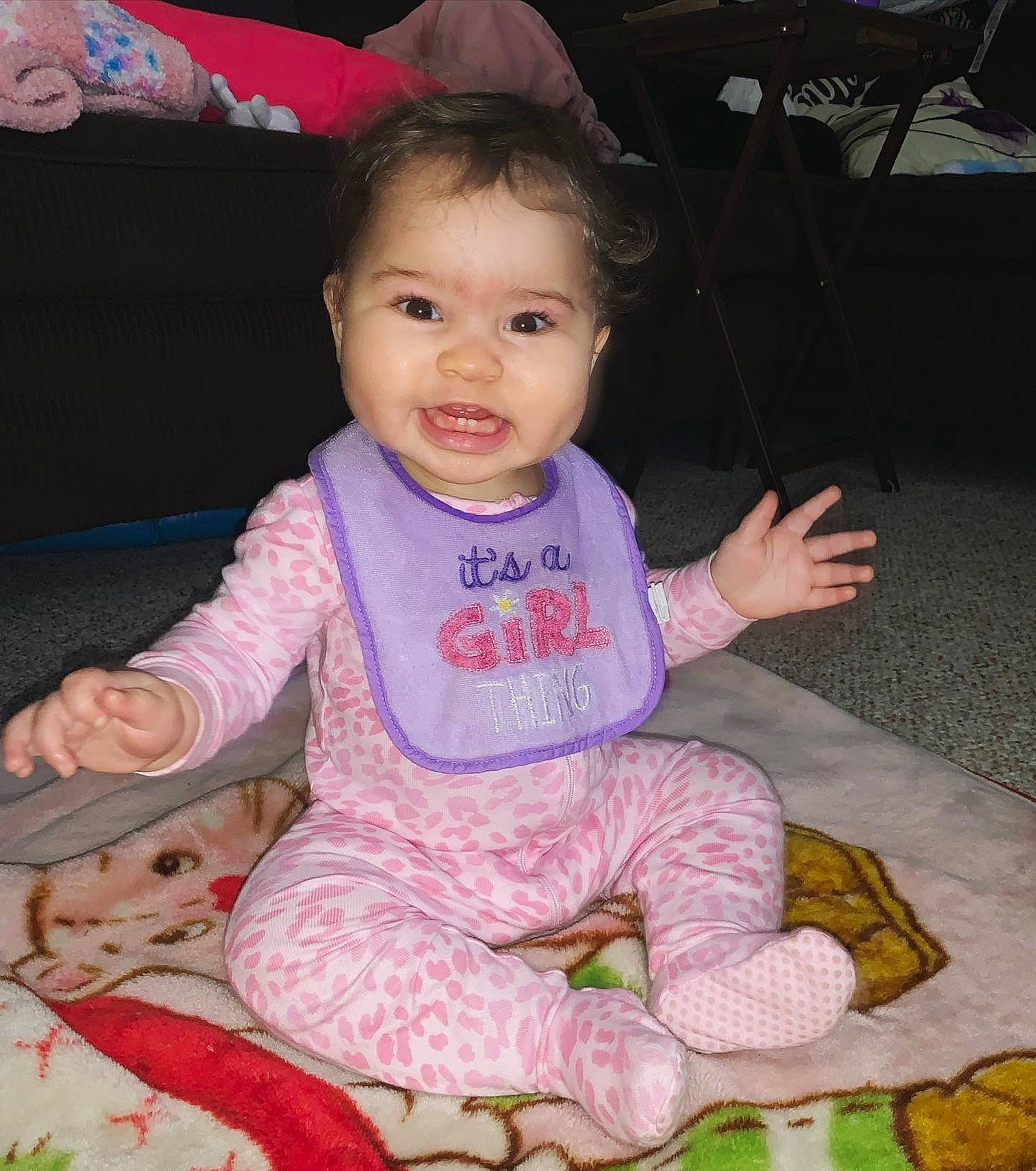 Elaïa is registered to the contest to win money with this photo: baby, baby_toddler_clothing, cheek, child, person, pink, sitting, skin, smile, toddler