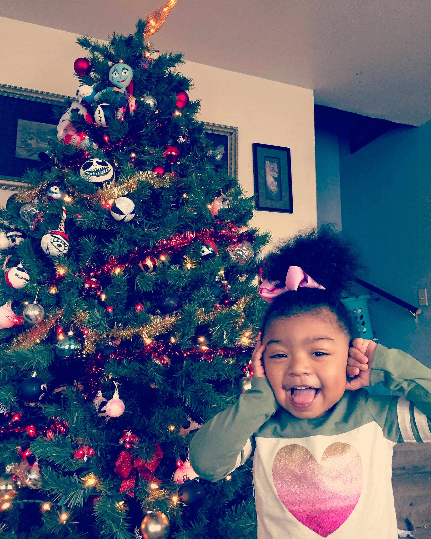 Janiyah Angela Soriano  is registered to the contest to win money with this photo: child, christmas, christmas_decoration, christmas_eve, christmas_ornament, christmas_tree, event, fir, happy, head, holiday, interior_design, joy, leaf, person, plant, sky, smile, toddler, tradition