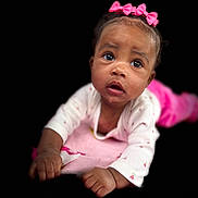 Keonna joined the competition — help win amazing prizes! baby, child, infant, pink_bow, pajamas, blanket, face, hands, portrait, cute, wide_eyes, indoor, soft_lighting, black_background, closeup, adorable, young_child, expression, skin, person