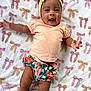 Keonna joined the competition — help win amazing prizes! baby, infant, smiling, headband, bow, shirt, floral_shorts, blanket, pattern, cute, happy, lying_down, skin, arm, leg, child, toddler, indoors, portrait, colorful
