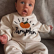 Joey joined the competition — help win amazing prizes! baby, infant, child, sitting, clothing, sweatshirt, pumpkin, cozy, socks, couch, gray, cute, expression, wide_eyes, soft, indoors, portrait, hands, feet, warm