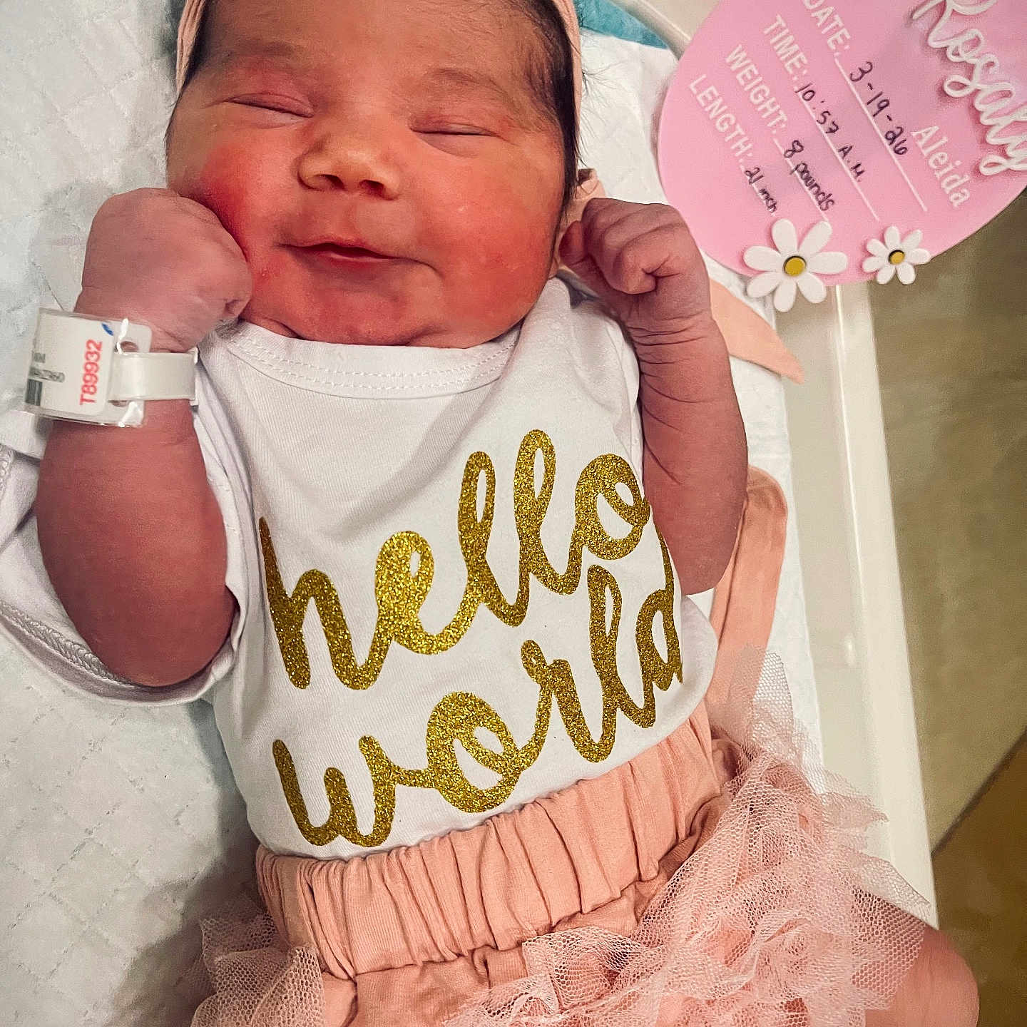 Rosaly Aleida Corzo is registered to the contest to win money with this photo: baby, birth_announcement, bracelet, clothing, cute, face, hand, headband, hospital, hospital_bed, infant, lying_down, newborn, person, pink, ruffle_skirt, skin, sleepy, smiling, text